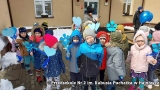 Dzieci trzymające w rękach niebieskie serca i niebieskie balony.