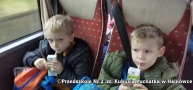 chłopcy w autokarze piją soczki