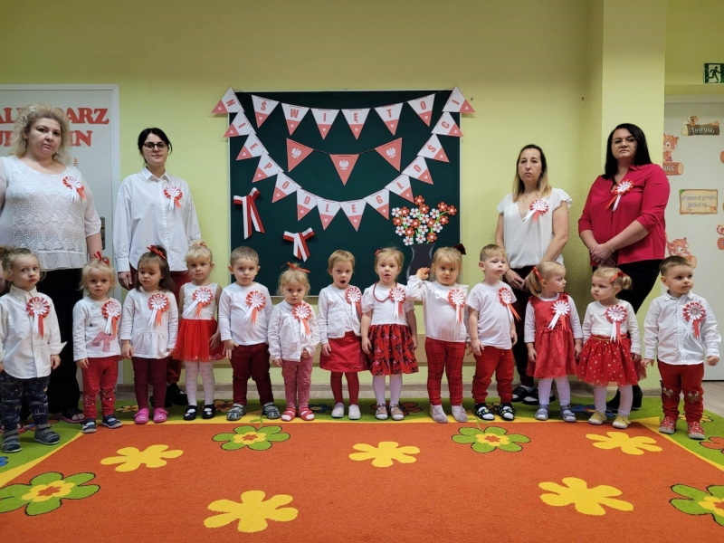 Zdjęcie grupowe dzieci i opiekunek, dzieci ubrane w biało - czerwone barwy.