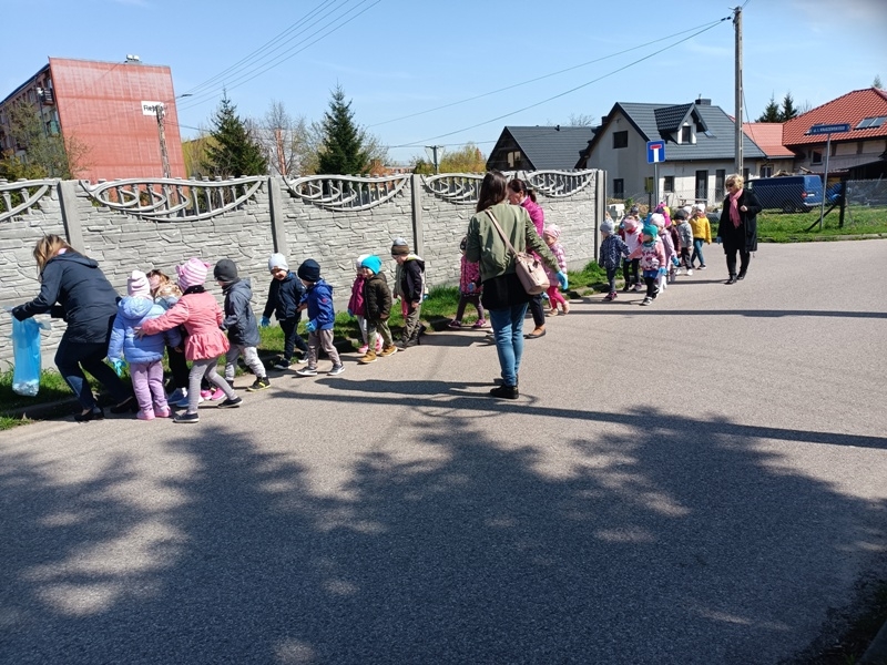 dwóch chłopców wrzuca worek do kosza