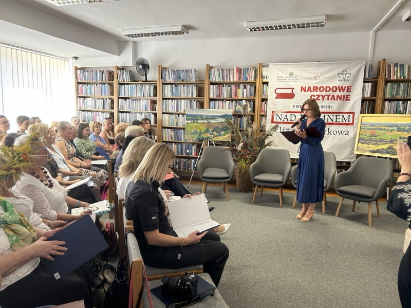 Dyrektor biblioteki podczas rozpoczęcia uroczystości stoi przed publicznością.