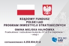 na jasnym szarym tle, w które wkomponowany jest znak orła, u góry flaga Polski i Godło, poniżej nazwa źródła dofinansowania, nazwa projektu i kwota dfinansowania, w prawym dolnym rogu logo Polskiego Ładu