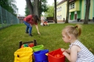 dziecko siedzi przy kolorowych torbach z piłeczkami