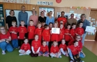 grupa dzieci w czerwonych koszulkach i naczyciele z Polski i Niemiec pozują do zdjęcia